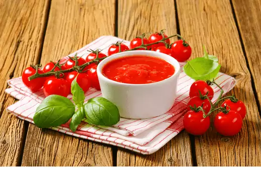 Tomato puree is a thick, red paste made from cooked tomatoes.