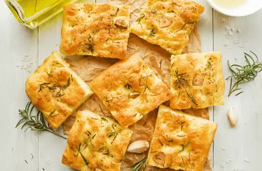 Focaccia is a type of Italian flatbread that's similar to garlic bread but without garlic.