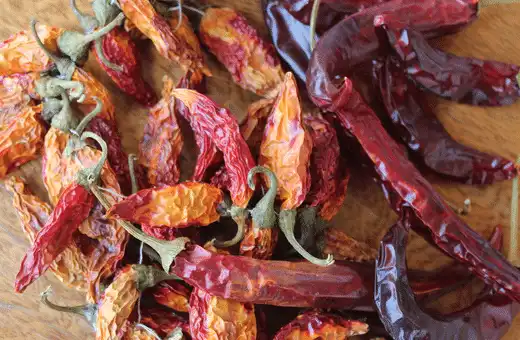 If you are looking for a smoky, fiery flavor than the zesty kick of sport peppers, try subbing Chipotle peppers.