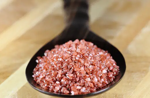Hawaiian red salt is pinkish-red unrefined sea salt that gets its unique hue from volcanic clay called Alaea, which gives it a slightly earthy mineral taste that's great for seasoning seafood and pork dishes.